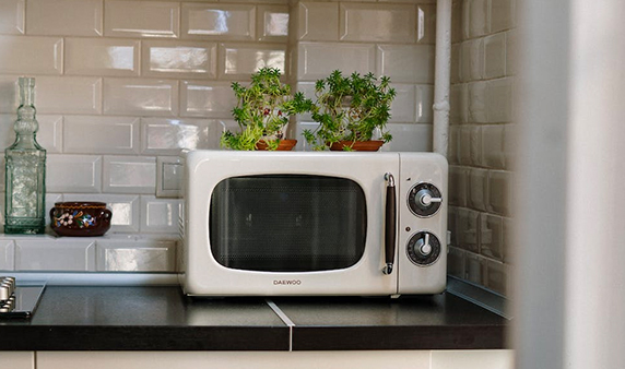 https://www.nicetystainless.com/wp-content/uploads/2022/12/Silver-Microwave-Oven-on-White-Wooden-Cabinet.jpg